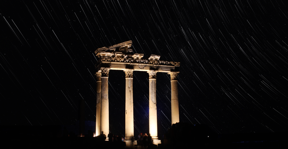 illuminated ancient temple columns at night