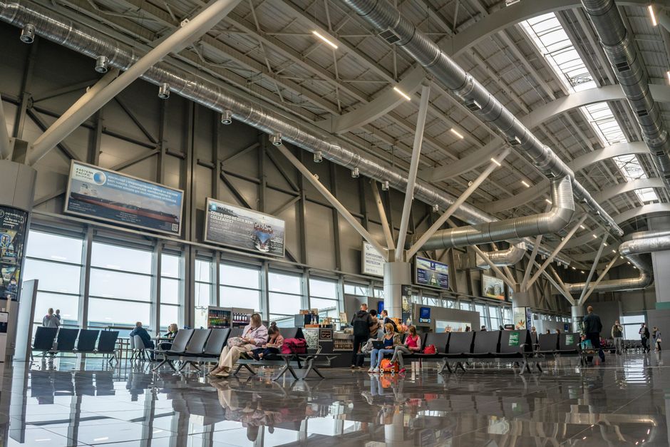 airport arrivals hall with travelers