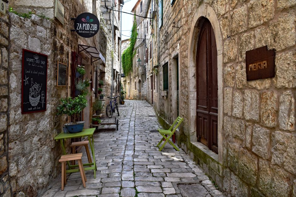 narrow old town street with shops and cafes