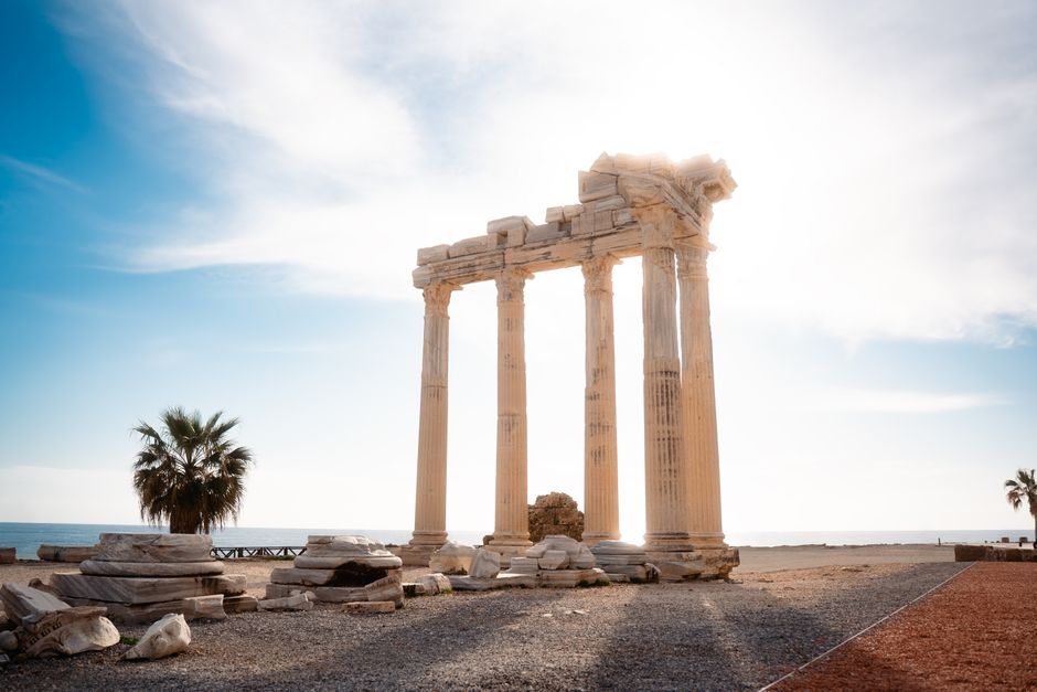 ancient temple columns at sunset by the sea